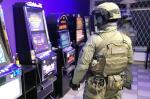 Uzbrojeni funkcjonariusze KAS wewnątrz nielegalnego salonu z automatami do gier hazardowych